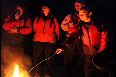 a group of people standing around a fire