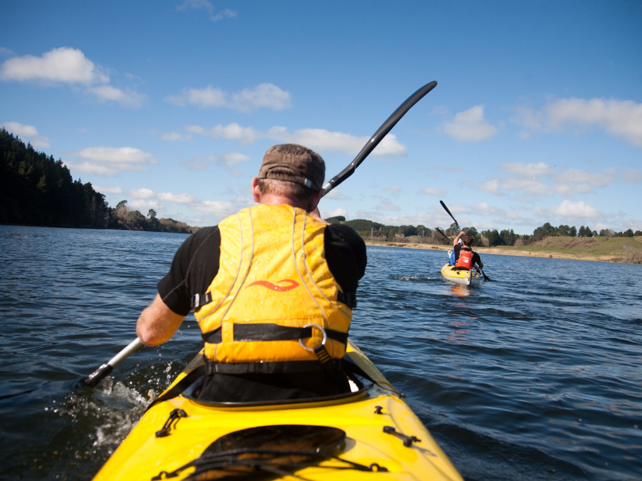 a man rowing a boat in a body of water