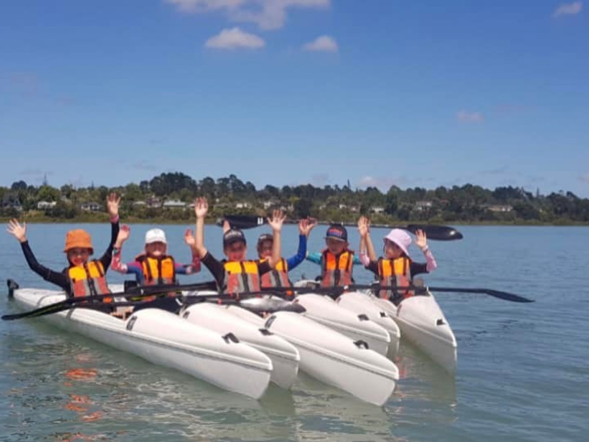 a group of people in a boat on a body of water