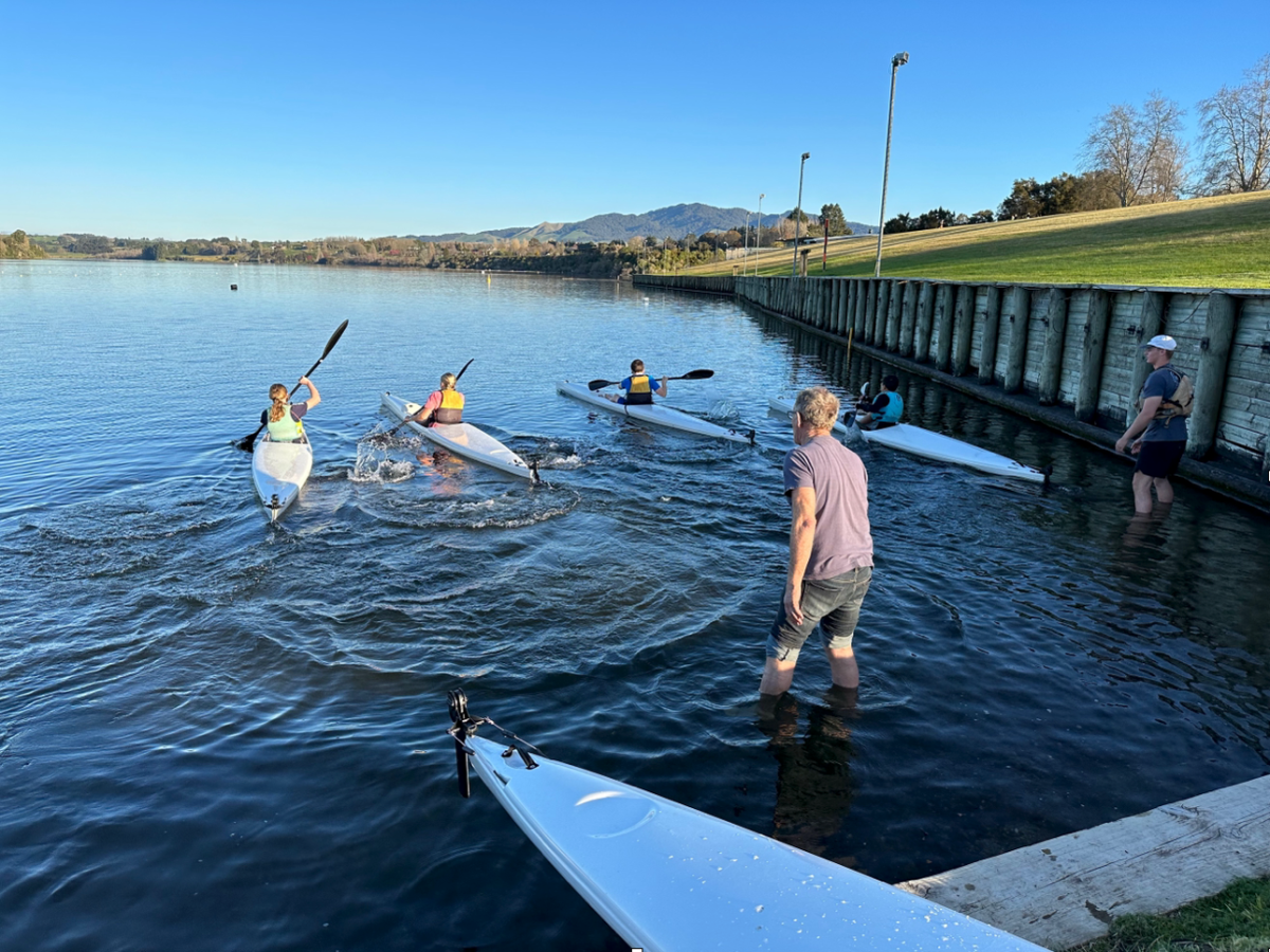 a group of people in a boat on a body of water